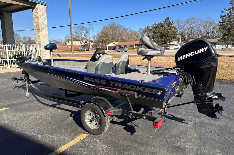 Slide: The Image of 2011 Tracker Pro Team 175 TF bass boat with Mercury outboard motor on trailer. - 3