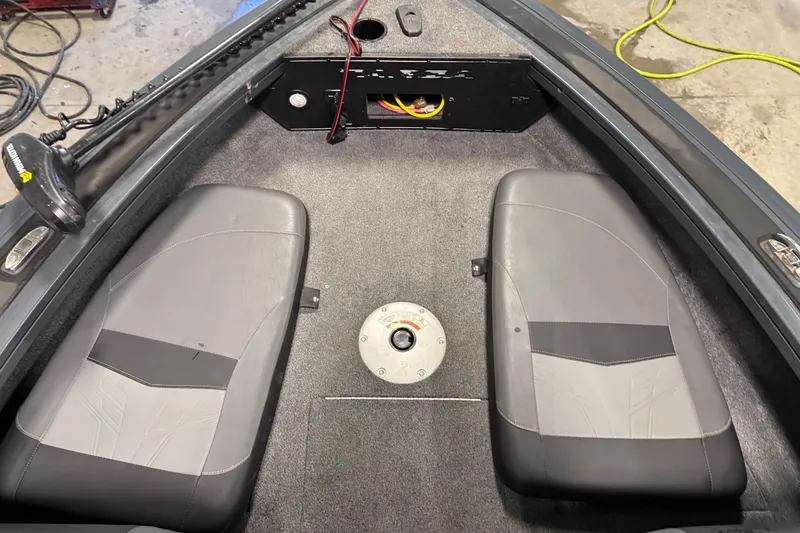 Slide: The Image of 2022 Tracker Targa V-18 WT boat interior with dual seats and storage compartment. - 13