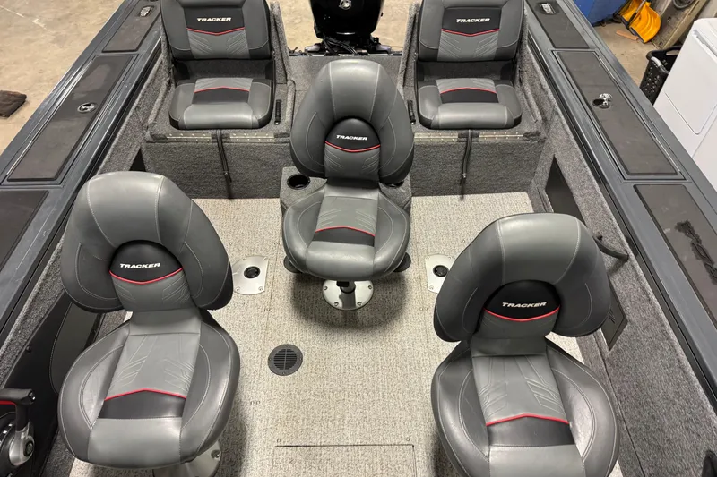 Slide: The Image of 2022 Tracker Targa V-18 WT boat interior with five gray seats and storage compartments. - 16