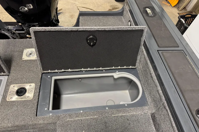 Slide: The Image of 2022 Tracker Targa V-18 WT boat storage compartment with open lid, showcasing interior space. - 17