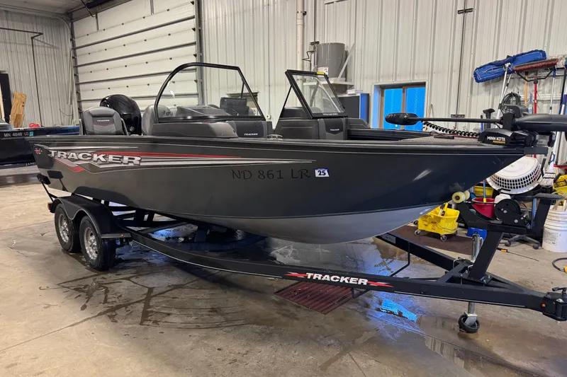 Slide: The Image of 2022 Tracker Targa V-18 WT boat on trailer in garage setting. - 2