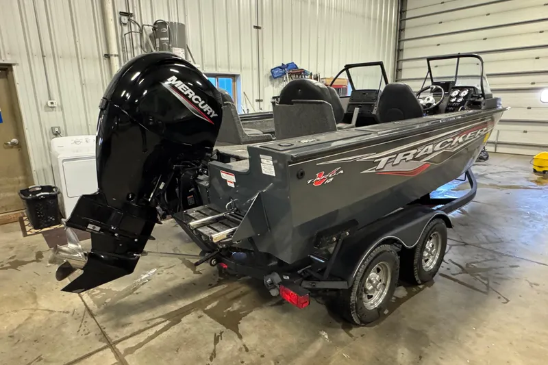 Slide: The Image of 2022 Tracker Targa V-18 WT boat with Mercury outboard motor in garage. - 3