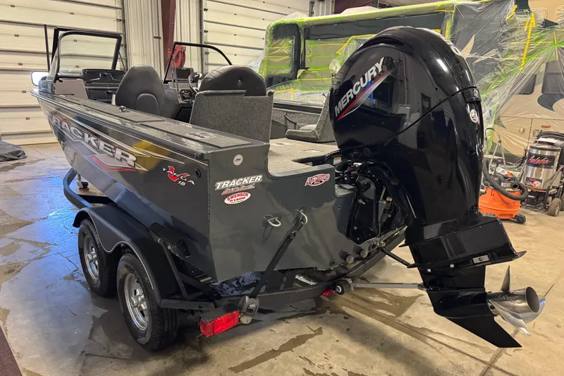 Slide: The Image of 2022 Tracker Targa V-18 WT boat with Mercury outboard motor in a garage. - 4