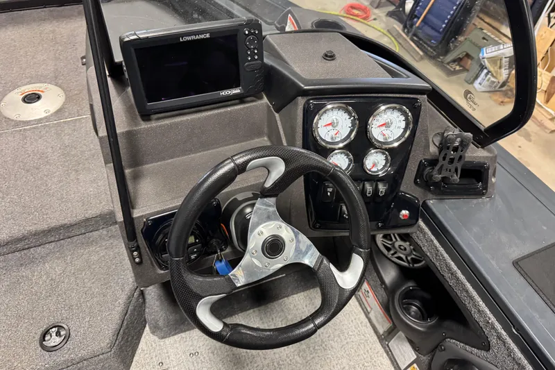 Slide: The Image of 2022 Tracker Targa V-18 WT boat dashboard with steering wheel and gauges. - 9