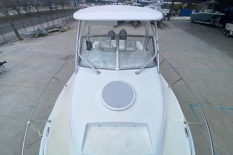 Slide: The Image of 2006 Polar 2300 Walkaround boat, docked, showcasing front deck and windshield. - 10