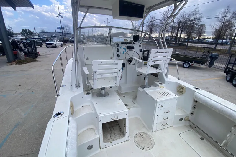 Slide: The Image of 2006 Polar 2300 Walkaround boat interior with helm, seating, and storage compartments. - 12