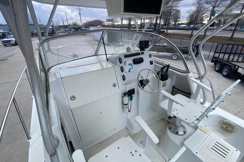 Slide: The Image of 2006 Polar 2300 Walkaround boat cockpit with steering wheel and seating. - 15