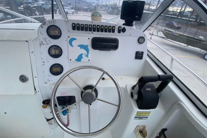 Slide: The Image of 2006 Polar 2300 Walkaround boat dashboard with steering wheel and control panel. - 16