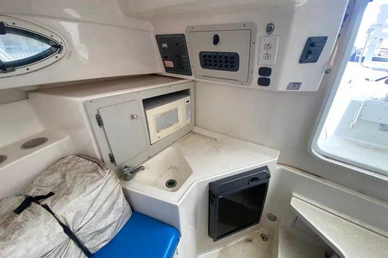 Slide: The Image of 2006 Polar 2300 Walkaround cabin interior with microwave, sink, and storage. - 19