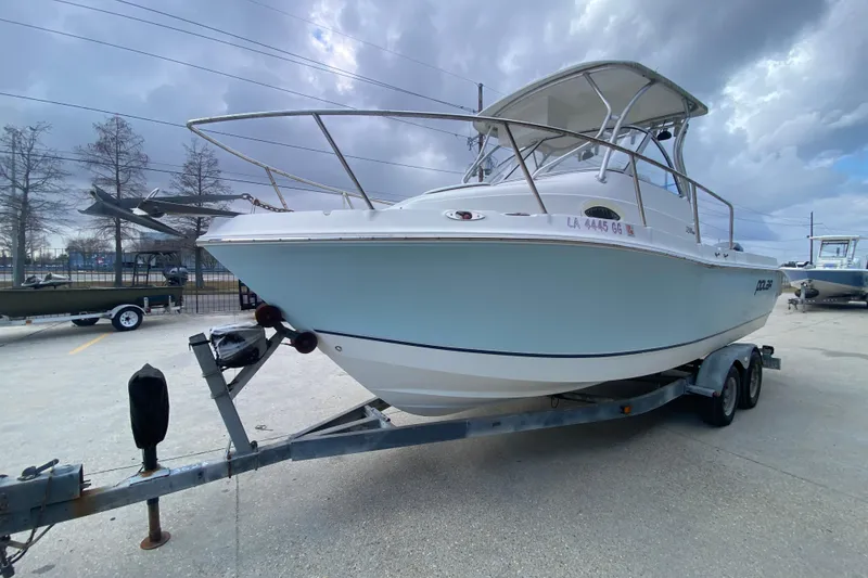 Slide: The Image of 2006 Polar 2300 Walkaround boat on trailer under cloudy sky. - 7