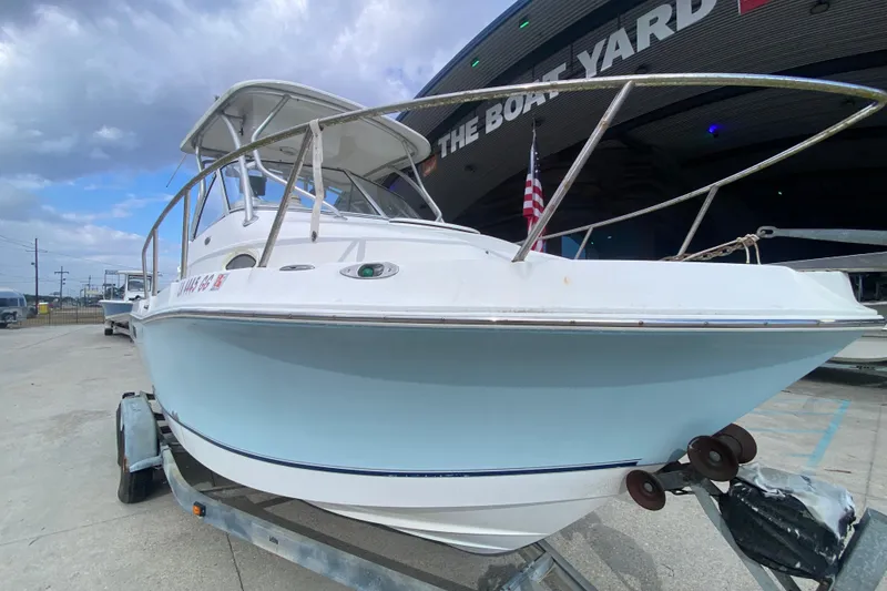 Slide: The Image of 2006 Polar 2300 Walkaround boat on trailer at The Boat Yard, under cloudy sky. - 9