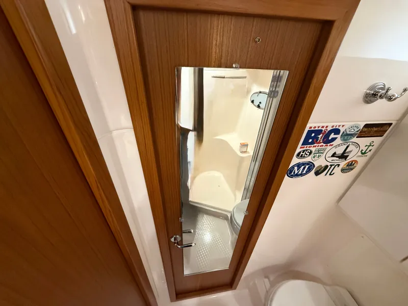 Slide: The Image of Bathroom in 2004 Tiara Yachts 42 Open with mirror and stickers. - 37