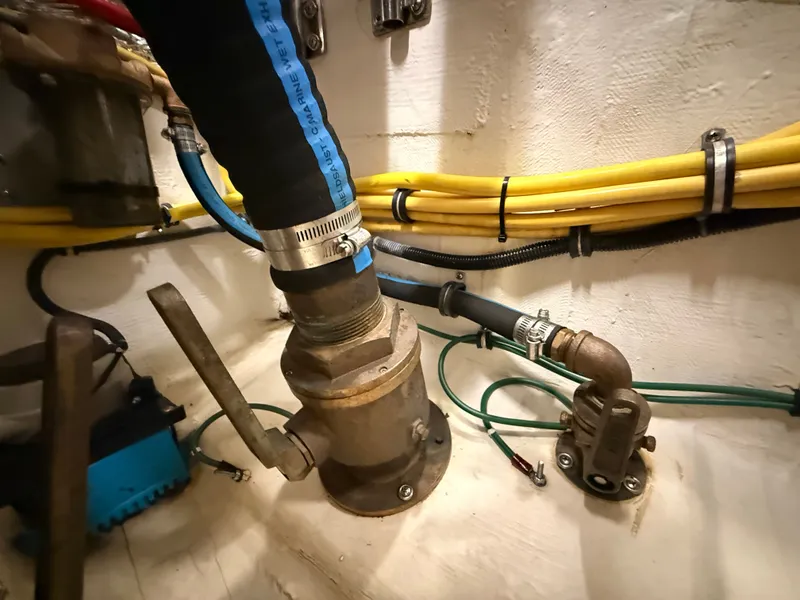 Slide: The Image of Engine room of a 2004 Tiara Yachts 42 Open with hoses and valves. - 43