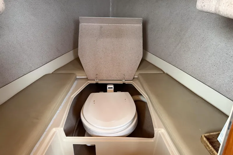 Slide: The Image of 2007 Duffield Cutty Cabin interior with compact marine toilet and cushioned seating. - 4