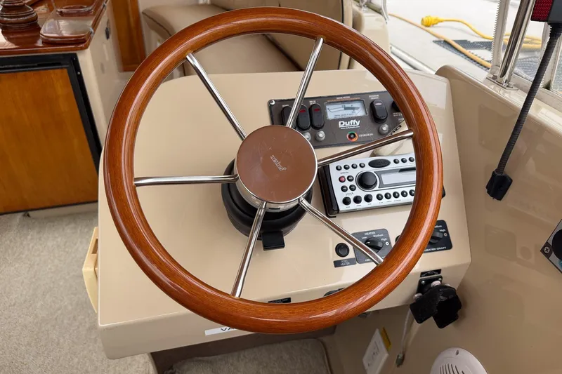Slide: The Image of Steering wheel and controls of a 2007 Duffield Cutty Cabin boat. - 6