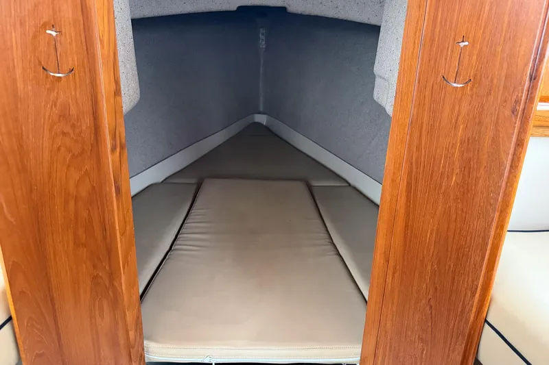 Slide: The Image of 2007 Duffield Cutty Cabin interior with wooden finish and cushioned sleeping area. - 8