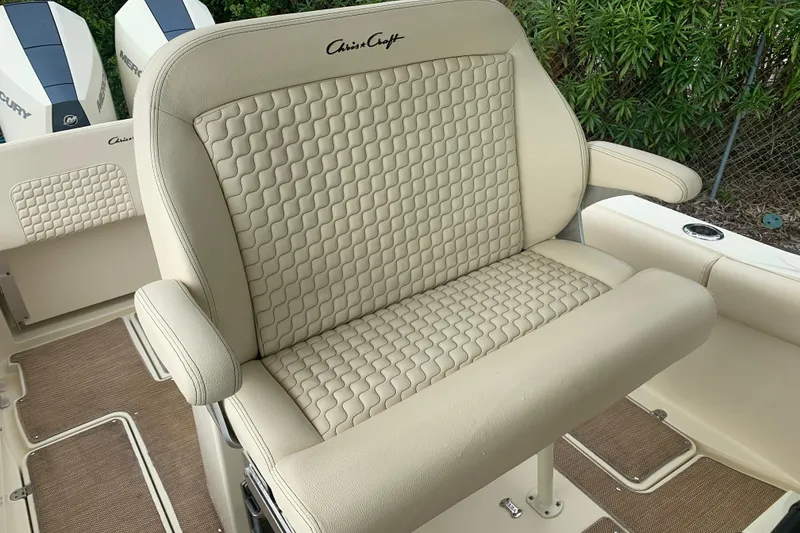 Slide: The Image of 2019 Chris-Craft Catalina 27 boat seat with beige quilted upholstery and armrests. - 11