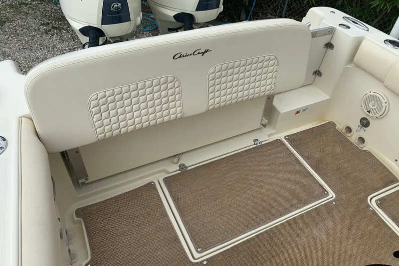 Slide: The Image of 2019 Chris-Craft Catalina 27 boat interior with cushioned seating and dual outboard motors. - 13