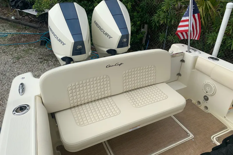 Slide: The Image of 2019 Chris-Craft Catalina 27 boat with dual Mercury engines and American flag. - 15