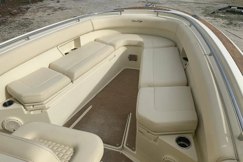 Slide: The Image of 2019 Chris-Craft Catalina 27 interior with beige seating and cup holders. - 18