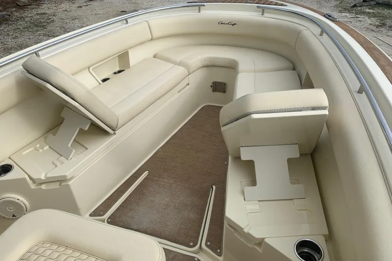 Slide: The Image of 2019 Chris-Craft Catalina 27 interior with beige seating and cup holders. - 19