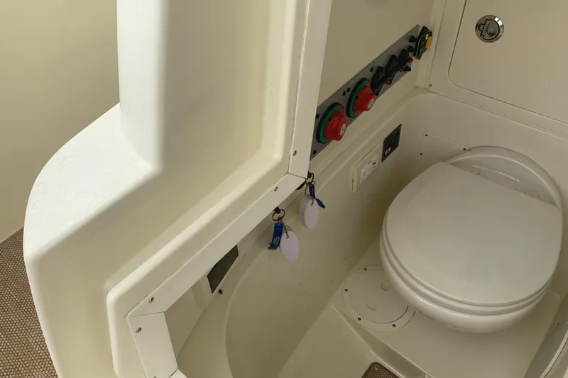 Slide: The Image of 2019 Chris-Craft Catalina 27 boat interior with toilet and control panel. - 24
