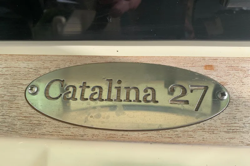 Slide: The Image of 2019 Chris-Craft Catalina 27 nameplate on wooden surface. - 31