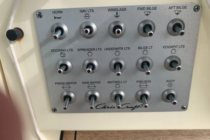 Slide: The Image of Control panel of a 2019 Chris-Craft Catalina 27 boat with labeled switches. - 33
