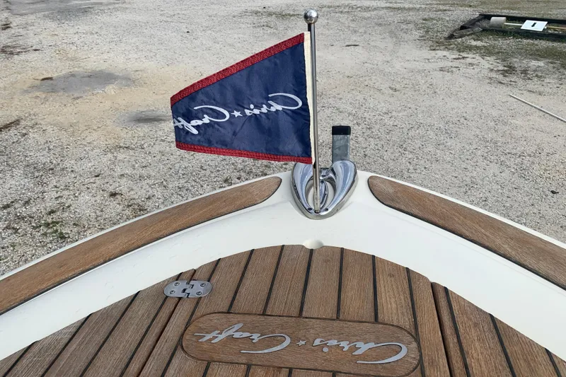 Slide: The Image of 2019 Chris-Craft Catalina 27 boat with branded flag and wooden deck detail. - 37