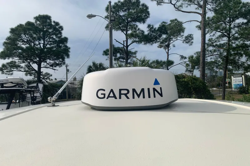 Slide: The Image of 2019 Chris-Craft Catalina 27 with Garmin radar, surrounded by trees and marina setting. - 47