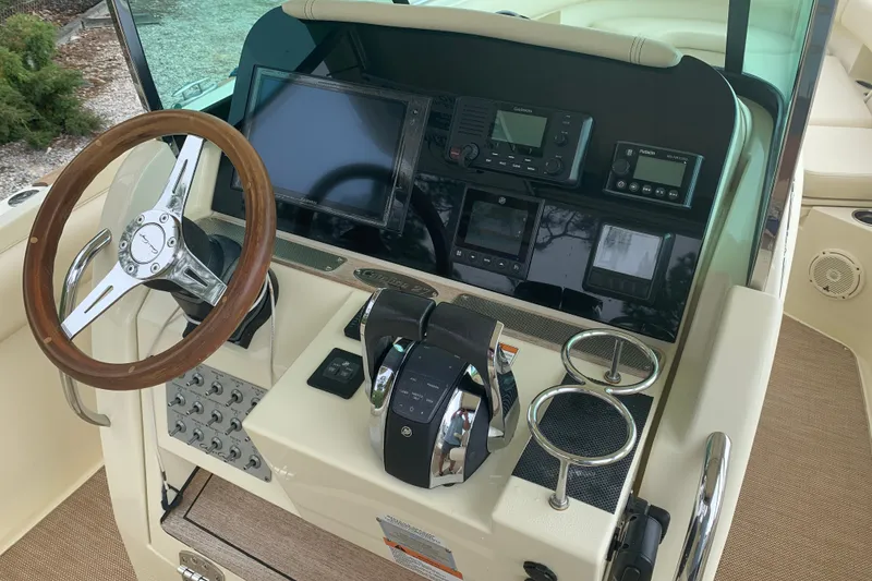 Slide: The Image of 2019 Chris-Craft Catalina 27 helm with steering wheel, controls, and navigation equipment. - 9