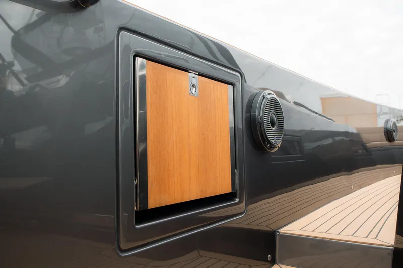 Slide: The Image of 2024 Pardo Yachts P43 exterior detail with wooden panel and speaker on sleek deck. - 31