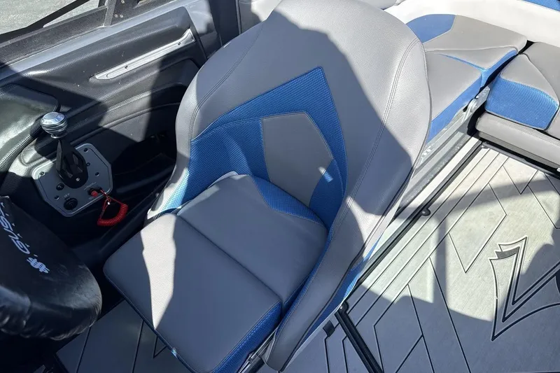 Slide: The Image of 2019 Supra SR boat interior with blue and gray seating and control panel. - 13
