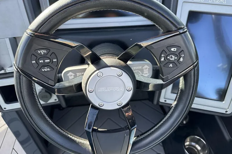 Slide: The Image of Steering wheel of 2019 Supra SR boat with integrated controls and touchscreen display. - 14