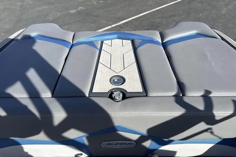 Slide: The Image of 2019 Supra SR boat interior with gray and blue upholstery, featuring sleek design elements. - 19
