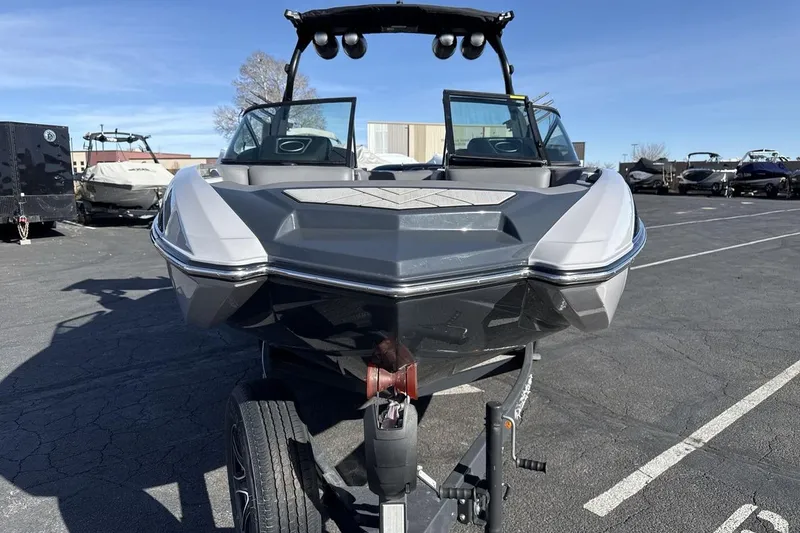 Slide: The Image of 2019 Supra SR boat on trailer in parking lot, front view. - 8