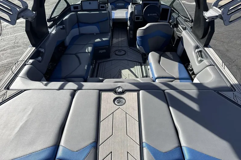 Slide: The Image of 2019 Supra SR boat interior with gray and blue seating, modern design. - 9