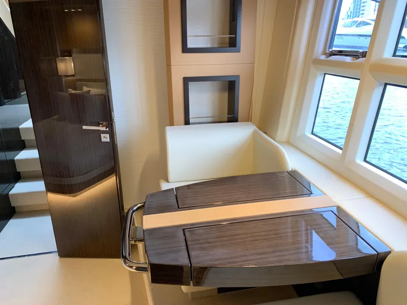 Slide: The Image of Interior of 2019 Azimut 77S yacht with modern seating and wooden table. - 19