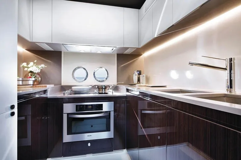 Slide: The Image of Modern kitchen interior on a 2019 Azimut 77S yacht with sleek cabinetry and stainless steel appliances. - 5