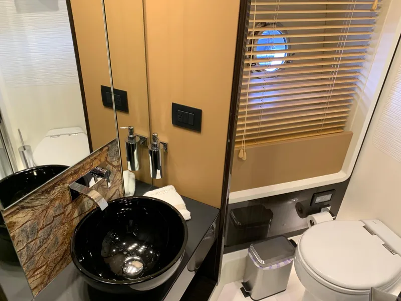 Slide: The Image of Modern bathroom on a 2019 Azimut 77S yacht with sleek fixtures and porthole window. - 25