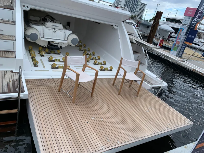 Slide: The Image of 2019 Azimut 77S yacht with open garage and two chairs on the deck. - 38
