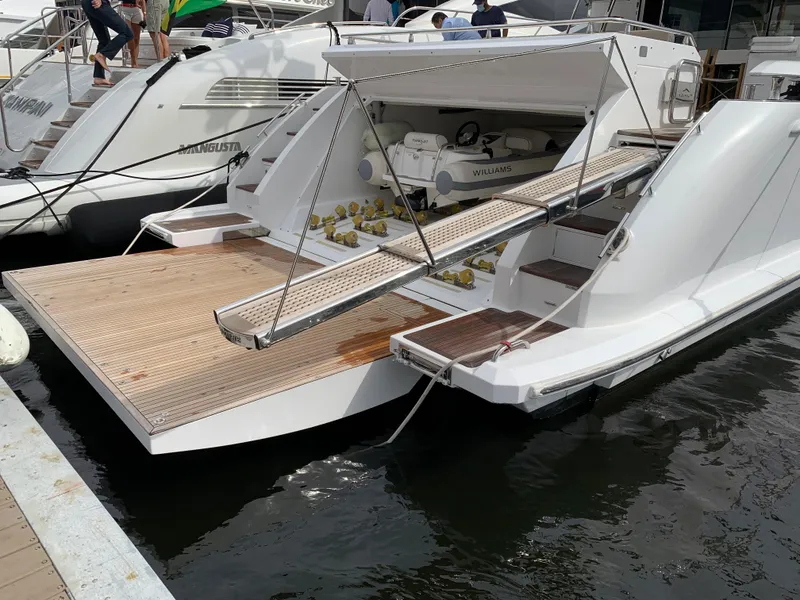 Slide: The Image of 2019 Azimut 77S yacht with open garage and tender at dock. - 37