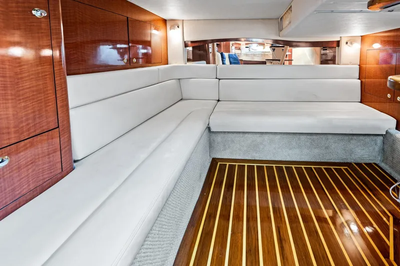Slide: The Image of Luxurious interior of 2003 Sea Ray 340 Sundancer with elegant wood finish and plush seating. - 10