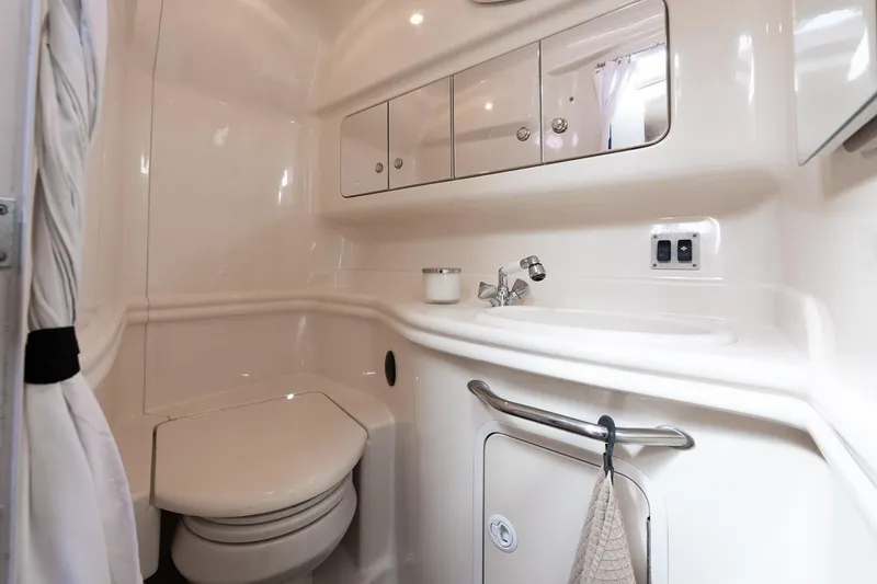 Slide: The Image of Luxurious bathroom in 2003 Sea Ray 340 Sundancer yacht, featuring modern fixtures and storage. - 11