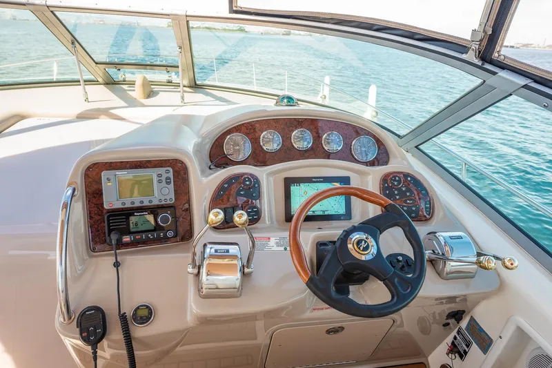 Slide: The Image of Helm of 2003 Sea Ray 340 Sundancer with navigation instruments and steering wheel. - 14