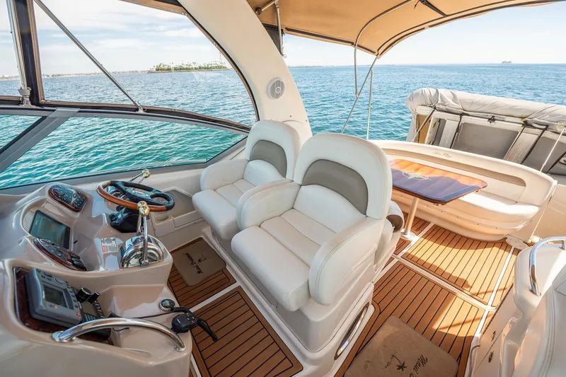 Slide: The Image of 2003 Sea Ray 340 Sundancer cockpit with luxurious seating and ocean view. - 17