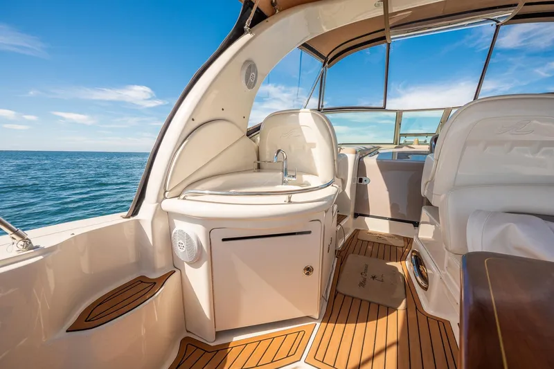 Slide: The Image of 2003 Sea Ray 340 Sundancer interior with sink, seating, and ocean view. - 18