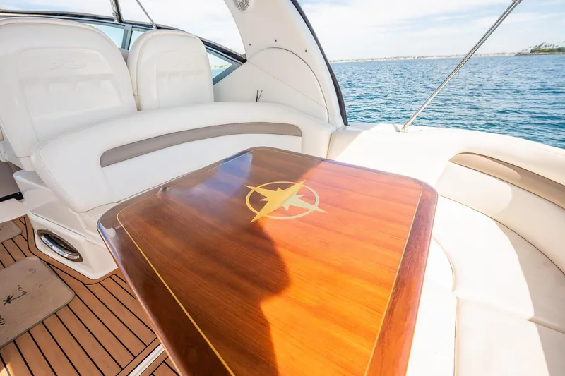Slide: The Image of Luxurious interior of 2003 Sea Ray 340 Sundancer yacht with elegant wood table. - 22