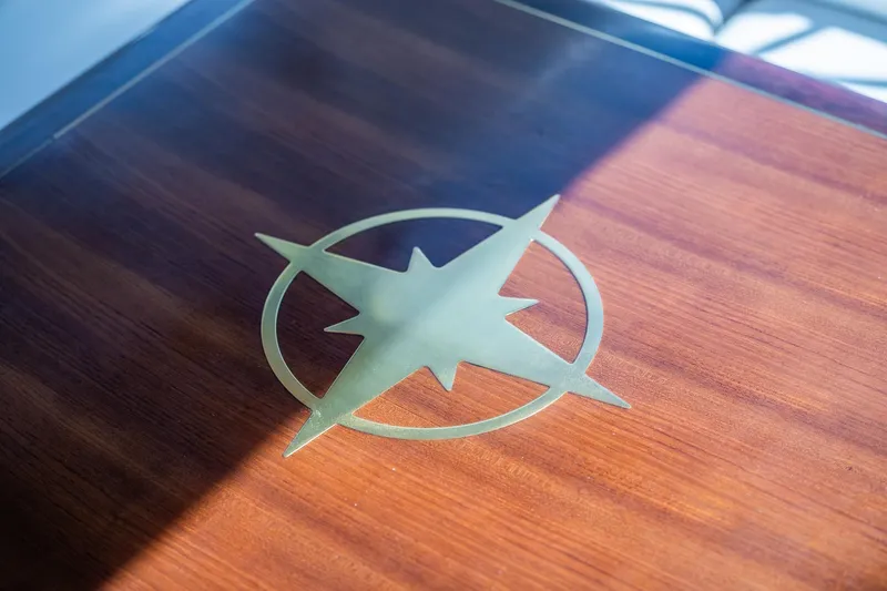 Slide: The Image of Wooden table with compass rose design on a 2003 Sea Ray 340 Sundancer yacht. - 23