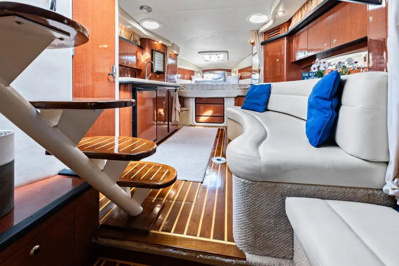 Slide: The Image of Luxurious interior of 2003 Sea Ray 340 Sundancer yacht with elegant seating and wooden accents. - 3